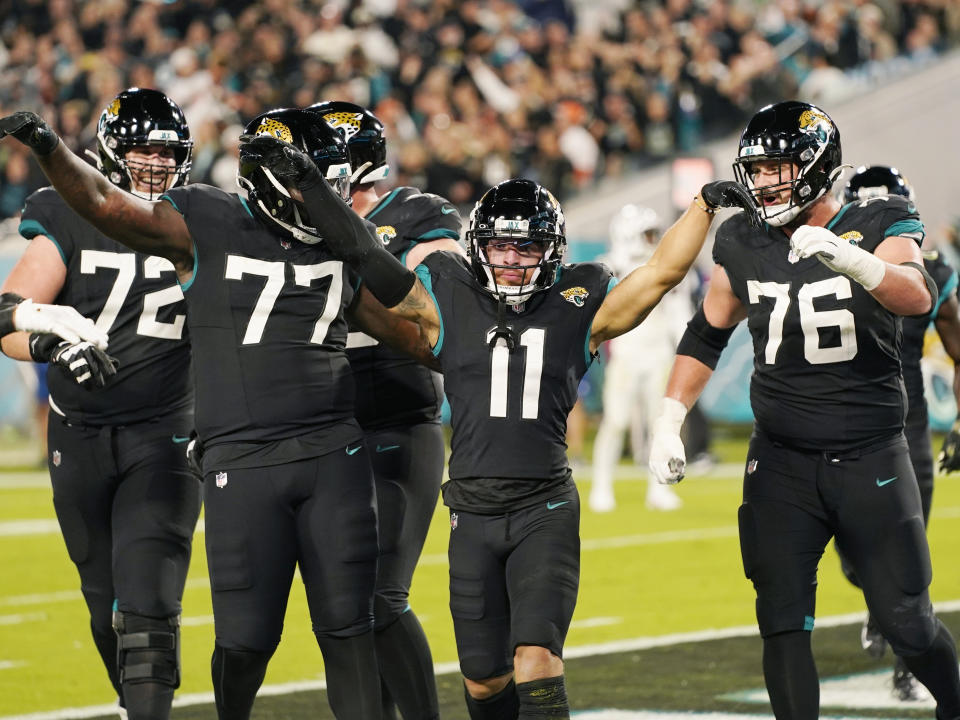 Jacksonville Jaguars wide receiver Parker Washington (11) celebrates after scoring a touchdown during the second half of an NFL football game, Monday, Dec. 4, 2023, in Jacksonville, Fla. (AP Photo/John Raoux)