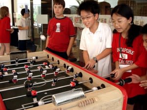 Students playing Foosball