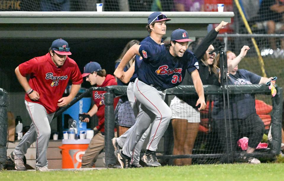The Bourne team, led by starter Bryce Cunningham, take to the field to celebrate with closer Justin Lovell who held off Orleans for a 6-4 win in the first game of the Cape League finals on Friday.