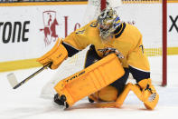 Nashville Predators goaltender Juuse Saros (74) deflects a shot against the Carolina Hurricanes during the first period of an NHL hockey game Saturday, May 8, 2021, in Nashville, Tenn. (AP Photo/Mark Zaleski)