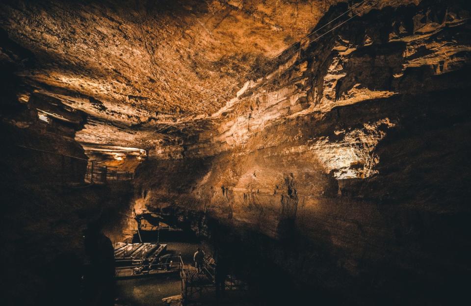 Members of the Indiana Geological and Water Survey carry their equipment down to the dock in 2019 at Bluespring Caverns south of Bedford to do water testing.