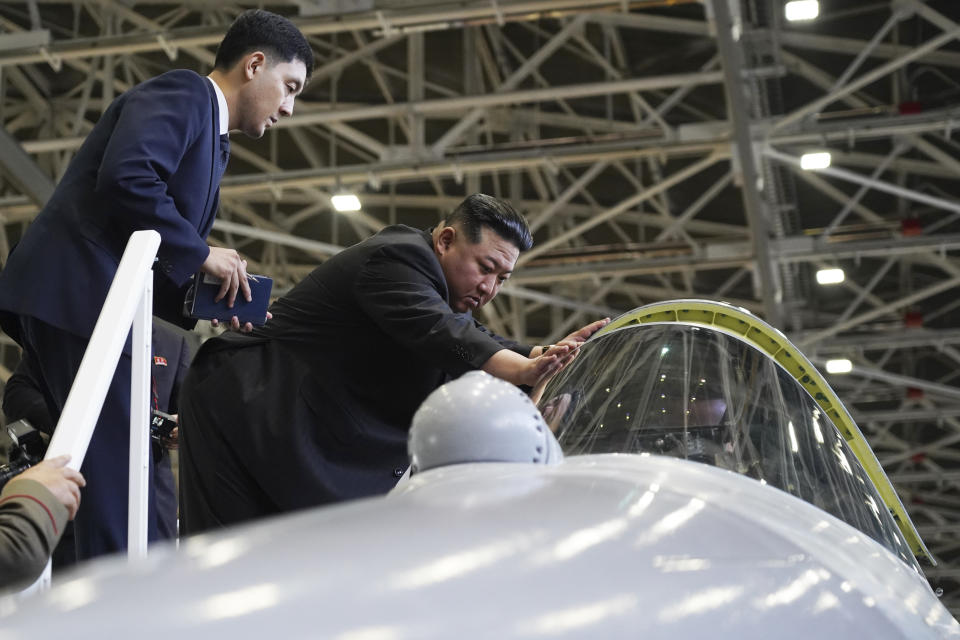 In this photo released by Khabarovsky Krai region government, North Korean leader Kim Jong Un, right, looks at a military jet cockpit while visiting a Russian aircraft plant that builds fighter jets in Komsomolsk-on-Amur, about 6,200 kilometers (3,900 miles) east of Moscow, Russia, Friday, Sept. 15, 2023. (Khabarovsky Krai region government via AP)