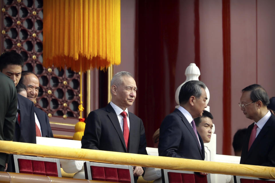 In this Oct. 1, 2019, photo, Chinese Vice Premier Liu He, center, stands on Tiananmen Gate near Tiananmen Square with other leaders before a parade to commemorate the 70th anniversary of the founding of Communist China. Liu will lead a delegation that includes China's commerce minister and central bank governor and industry, technology and agriculture regulators to Washington on Thursday for talks aimed at ending a tariff war, the Ministry of Commerce said Tuesday, Oct. 8, 2019. (AP Photo/Mark Schiefelbein)