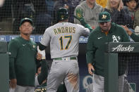 Oakland Athletics' Elvis Andrus is greeted at the dugout after he hit a solo home run during the seventh inning of a baseball game, Sunday, July 3, 2022, in Seattle. (AP Photo/Ted S. Warren)