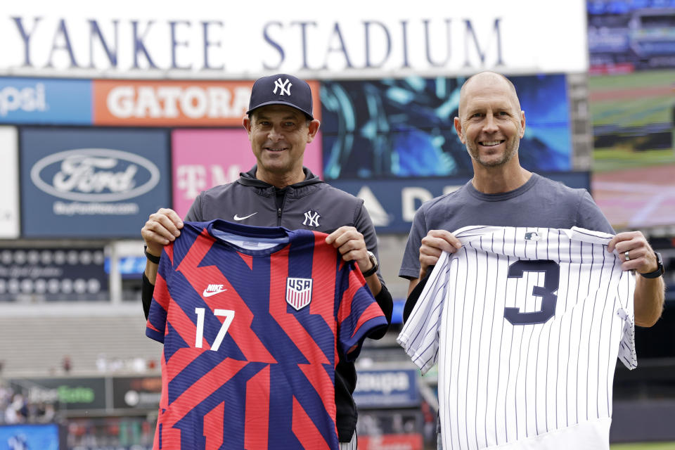 New York Yankees manager Aaron Boone, left, poses with U.S. men's national soccer team head coach Gregg Berhalter before the first baseball game of a doubleheader against the Minnesota Twins on Wednesday, Sept. 7, 2022, in New York. (AP Photo/Adam Hunger)