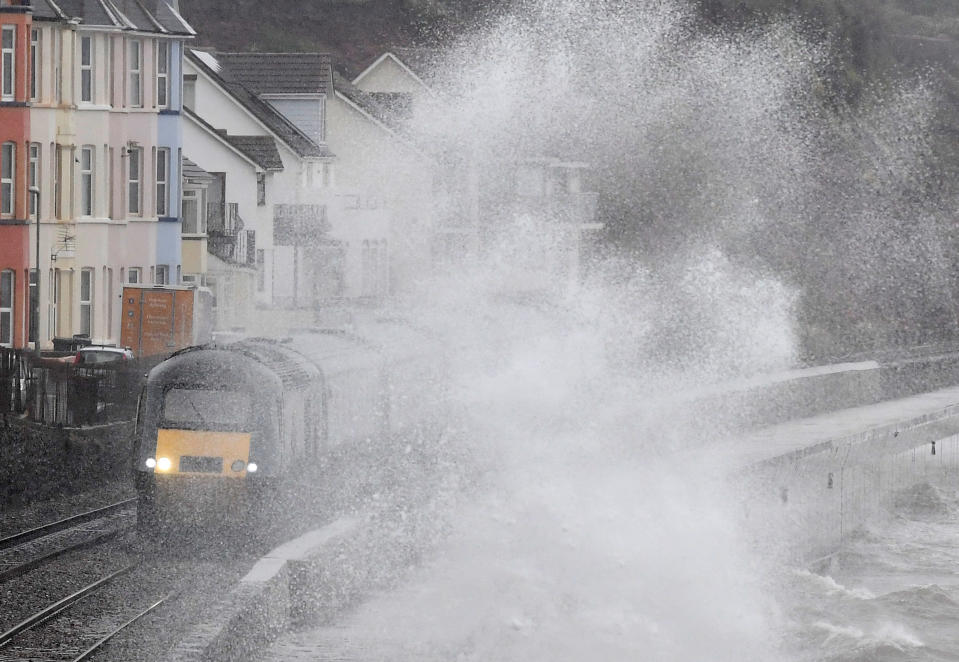 Large waves crash against the seawall during Storm Erik as a train passes through Dawlish in southwest Britain, February 8, 2019. REUTERS/Toby Melville