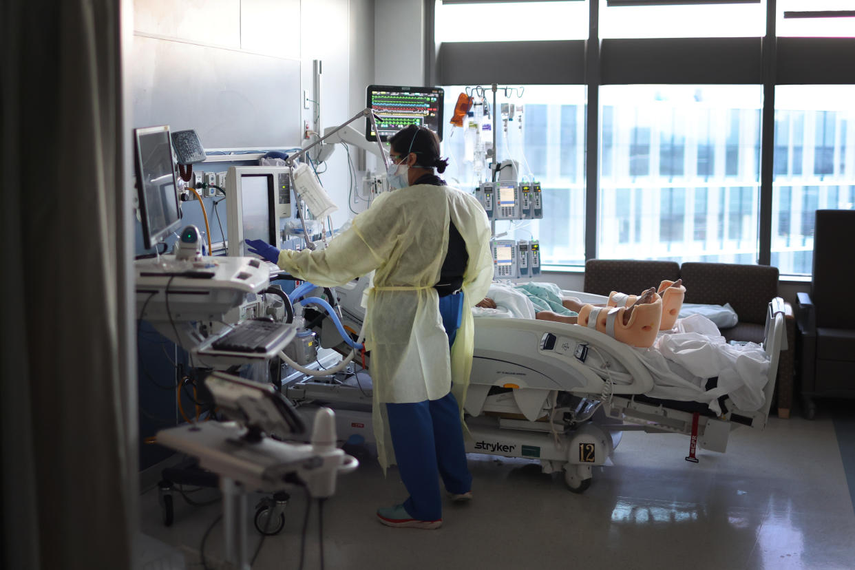 Respiratory Therapist Nirali Patel works with a COVID-19 patient at Rush University Medical Center in Chicago in 2022. 