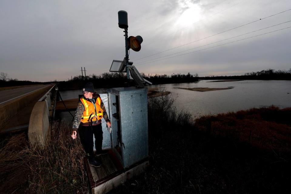 U.S. Geological Survey physical scientist Kendra Markland checks data gathered at a river flow monitoring station along the Cedar River Bridge near Palo, Iowa, November 14, 2022. The USGS collects water samples from the river once a month. The agency tests samples for several substances including nitrate level.