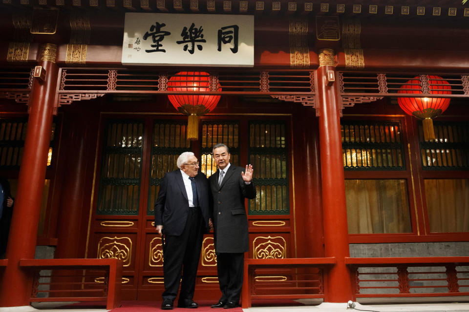 Kissinger with Wang Yi (Thomas Peter / AFP via Getty Images file)