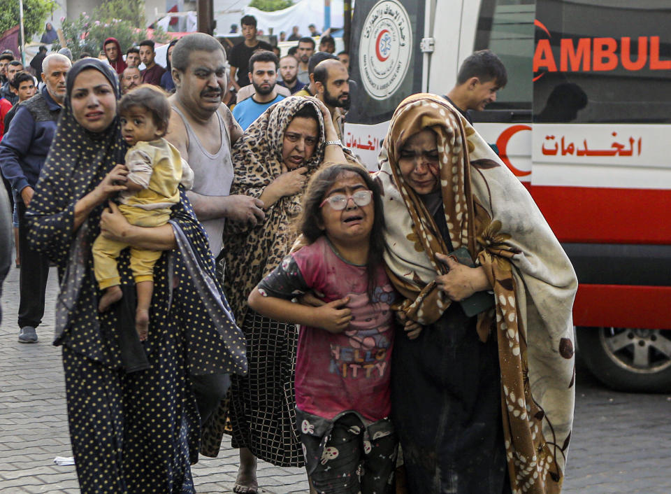 FILE - Injured Palestinians arrive at al-Shifa Hospital following Israeli airstrikes on Gaza City, central Gaza Strip, Monday, Oct. 16, 2023. Israel is sending top legal minds, including a Holocaust survivor, to The Hague this week to counter allegations that it is committing genocide against Palestinians in Gaza. (AP Photo/Abed Khaled, File)