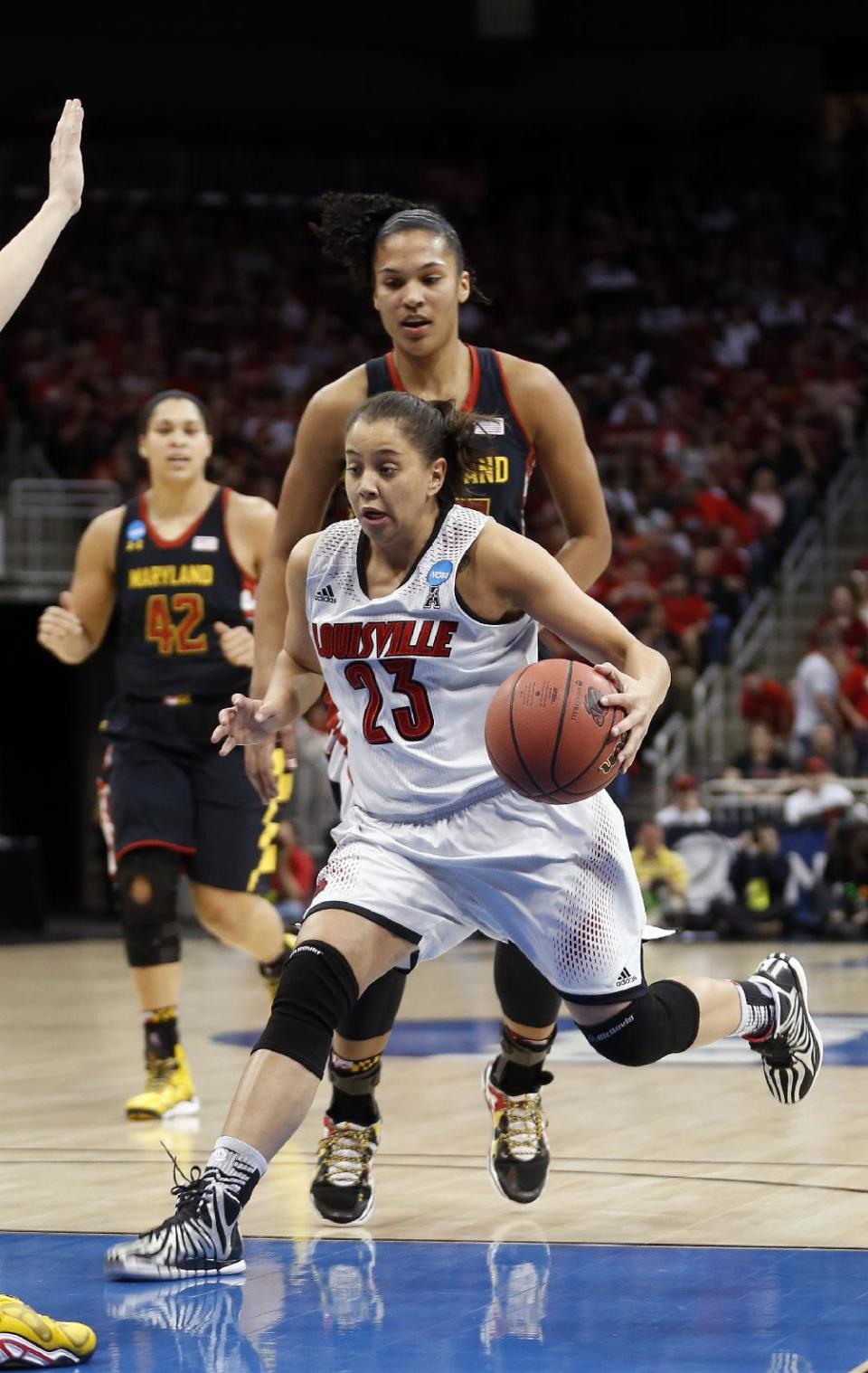 Louisville guard Shoni Schimmel (23) drives past Maryland forward Alyssa Thomas (25) during the first half of a regional final in the NCAA women's college basketball tournament, Tuesday, April 1, 2014, in Louisville, Ky. (AP Photo/John Bazemore)