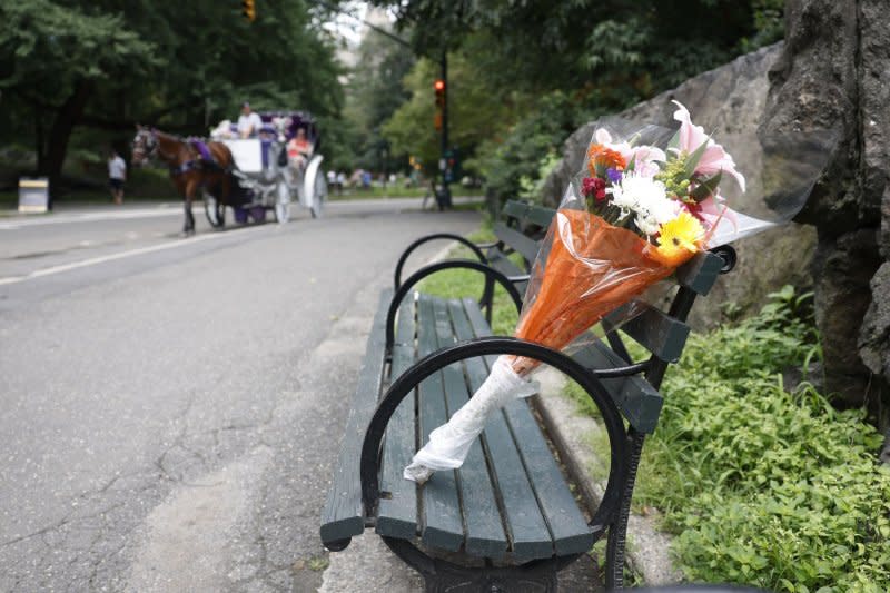 A bouquet of flowers rest on the Central Park bench dedicated to Tony Bennett in New York City on Friday. Photo by John Angelillo/UPI