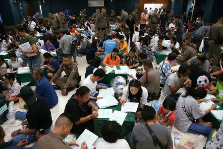 Bangkok district officers and police officers prepare ballot boxes and other documents ahead of the general election at a local district office in Bangkok, Thailand, March 23, 2019. REUTERS/Athit Perawongmetha