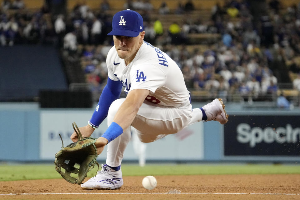 Los Angeles Dodgers third baseman Kiké Hernández fields a ball hit by San Diego Padres' Eguy Rosario during the seventh inning of a baseball game Wednesday, Sept. 13, 2023, in Los Angeles. Rosario was safe at first on the play. (AP Photo/Mark J. Terrill)