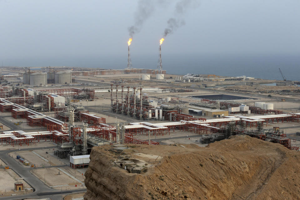 FILE - A natural gas refinery is visible at the South Pars gas field on the northern coast of the Persian Gulf, in Asaluyeh, Iran on March 16, 2019. The United Nations will require delegates attending its annual climate summit to disclose their affiliation in an effort to clamp down on undue influence by fossil fuel companies and others. (AP Photo/Vahid Salemi, File)