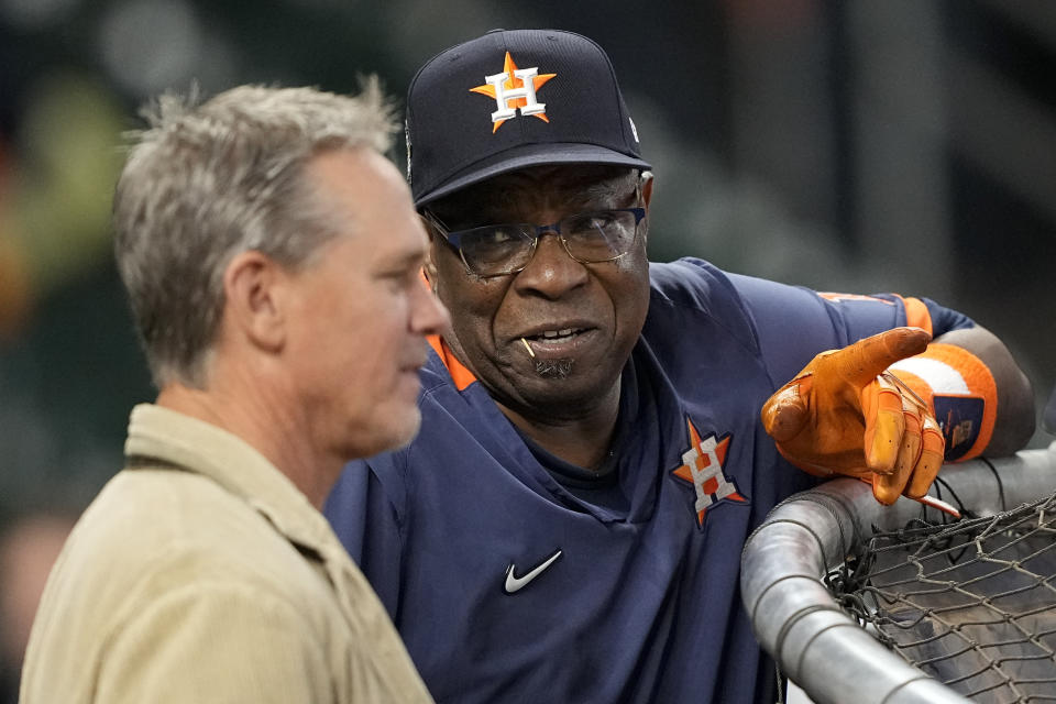 Houston Astros manager Dusty Baker Jr. speaks with former baseball player Craig Biggio, ahead of Game 2 of baseball's World Series between the Houston Astros and the Philadelphia Phillies on Saturday, Oct. 29, 2022, in Houston. (AP Photo/David J. Phillip)