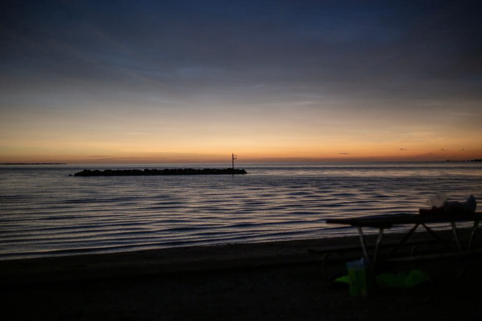 The skyline over Lake Erie turns colors as totality occurs Monday at East Harbor State Park in Ohio.