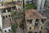 Heritage houses that were destroyed in Aug. 4 explosion that hit the seaport of Beirut, are seen hold by scaffolding, in Beirut, Lebanon, Thursday Aug. 27, 2020. In the streets of Beirut historic neighborhoods, workers are erecting scaffolding to support buildings that have stood for more than a century - now at risk of collapse after the massive Aug. 4 explosion that tore through the capital. (AP Photo/Hussein Malla)