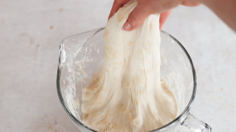 hand pulling sourdough in bowl