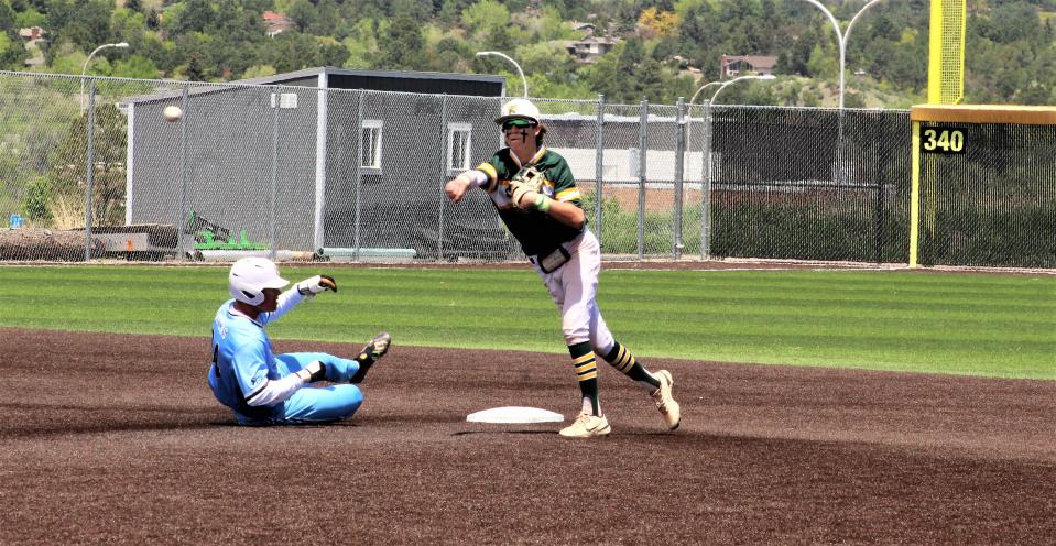 Parker Hankins of Pueblo County throws to first to complete the double play against Riverdale Ridge in the first game of the Colorado Class 4A state baseball tournament held at UCCS on May 26, 2023.