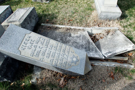 A headstone, pushed off its base by vandals, lays on the ground near a smashed tomb in the Mount Carmel Cemetery, a Jewish cemetery, in Philadelphia, Pennsylvania, U.S. February 27, 2017. REUTERS/Tom Mihalek