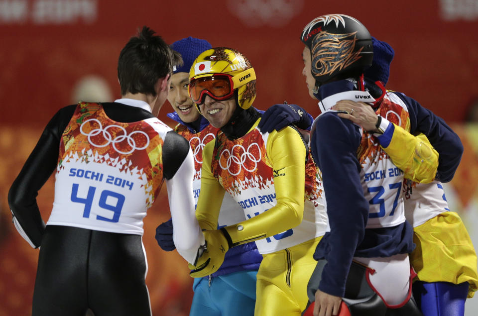 Japan's silver medal winner Noriaki Kasai congratulates Slovenia's bronze medal winner Peter Prevc, left, during the ski jumping large hill final at the 2014 Winter Olympics, Saturday, Feb. 15, 2014, in Krasnaya Polyana, Russia. (AP Photo/Matthias Schrader)