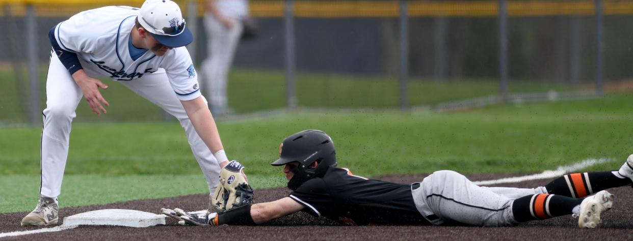 Hoover's Mason Ashby beats a tag at third from Louisville's Zach Root on a steal in the fourth inning at Louisville.  Friday,  April 14, 2023