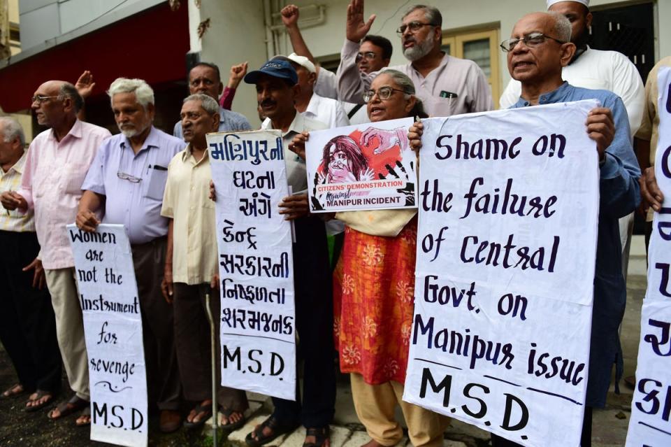 People hold placards during a protest over sexual violence against women and for peace in the ongoing ethnic violence in India's north-eastern state of Manipur, on July 20 (AFP via Getty Images)