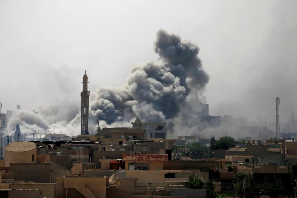 Smoke rises from an air strike during a battle between Iraqi forces and Isis in west Mosul (Reuters)