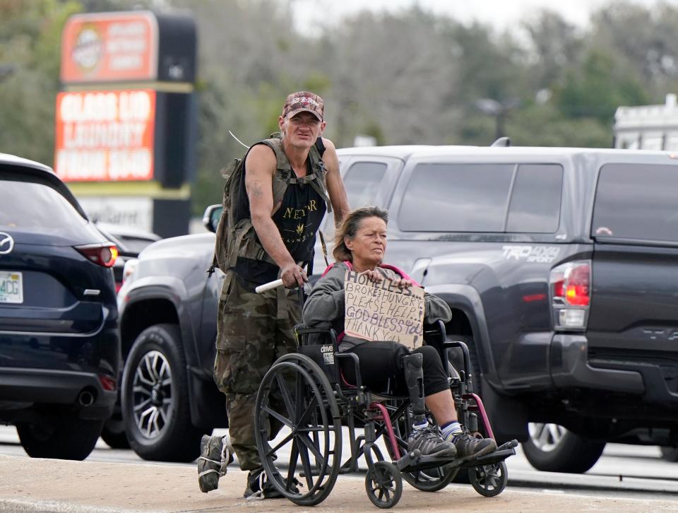 After the panhandling problem in Daytona Beach became ubiquitous in 2017 and 2018, the city passed new rules in early 2019 that nearly shut down panhandling. Since a judge issued a preliminary injunction on Daytona Beach's panhandling ordinance in August, the beggars have re-emerged. Pictured are two people who appear to be panhandling on Beville Road late last week.