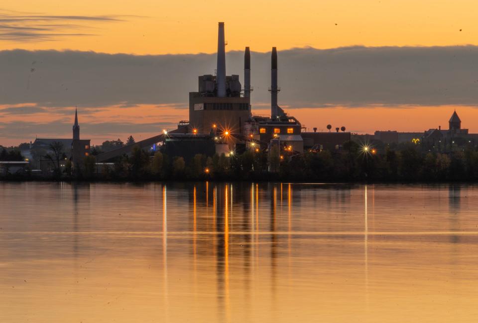 The sun rises over the Xcel Energy power plant on Lake Superior in Ashland.