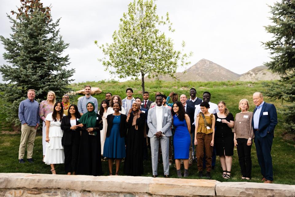 Graduates of the One Refugee program pose for a picture with leadership from the program during the One Refugee graduation celebration at the Garden Place at Heritage Park in Salt Lake City on May 8, 2023. | Ryan Sun, Deseret News