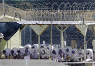 In this image approved for release by the U. S. military, detainees conduct morning prayers on March 28, 2009 at Camp 4 for cooperative captives at the U.S. Navy base at Guantanamo Bay, Cuba. (John VanBeekum/Miami Herald/MCT)