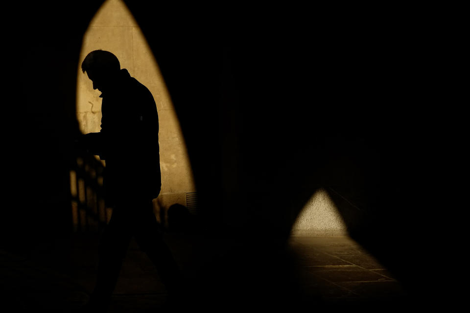 A person is silhouetted as the sun sets on a spring evening, in Pamplona, northern Spain, Tuesday, April 23, 2024. (AP Photo/Alvaro Barrientos)