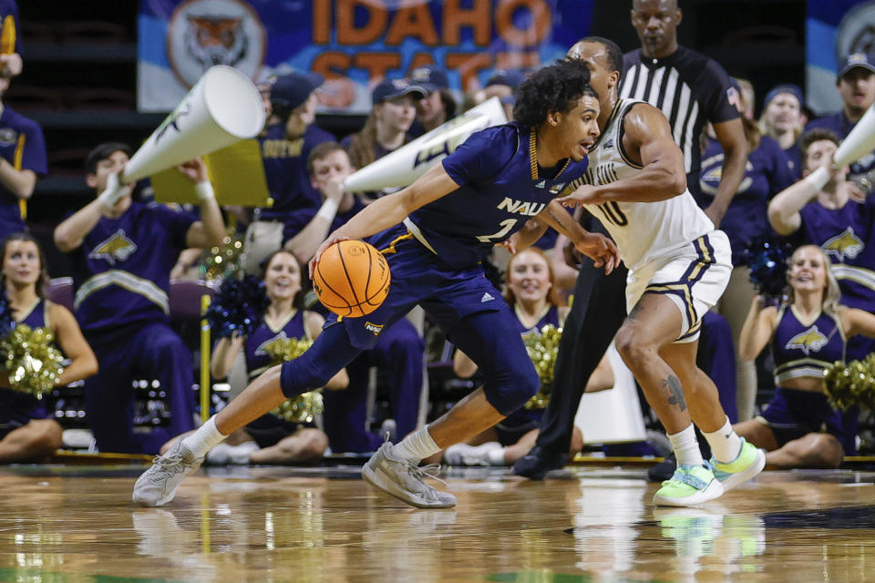 Northern Arizona guard Xavier Fuller (2) drives with the ball against Montana State guard Darius Brown II (10) in the first half of an NCAA college basketball game for the championship of the Big Sky men's tournament in Boise, Idaho, Wednesday, March 8, 2023. (AP Photo/Steve Conner)