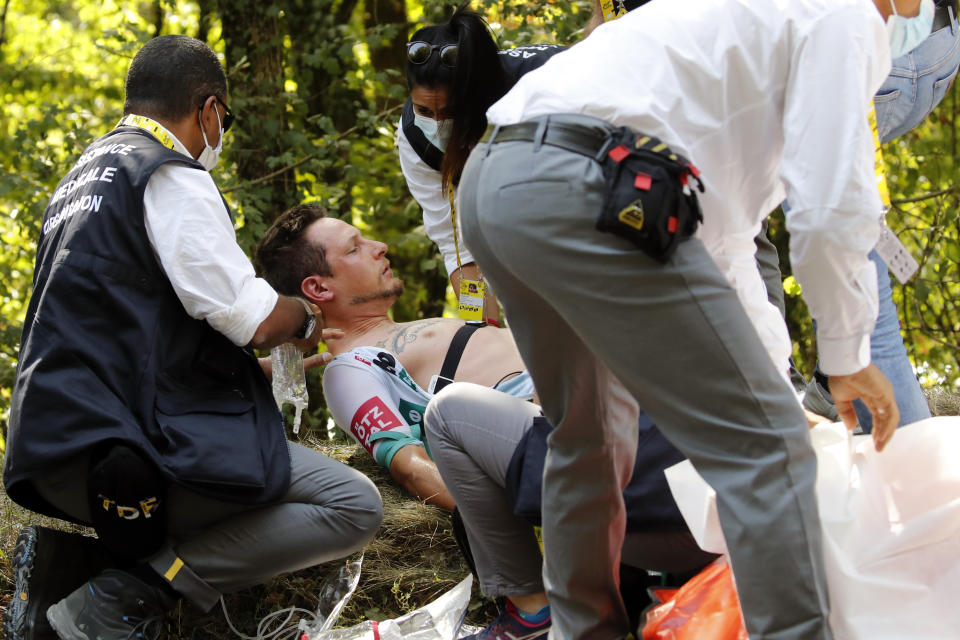 Lukas Postlberger of Austria is treated by medics during the stage 19 of the Tour de France cycling race over 166 kilometers (103 miles), with start in Bourg-en-Bresse and finish in Champagnole, Friday, Sept. 18, 2020. (AP Photo/Christophe Ena)
