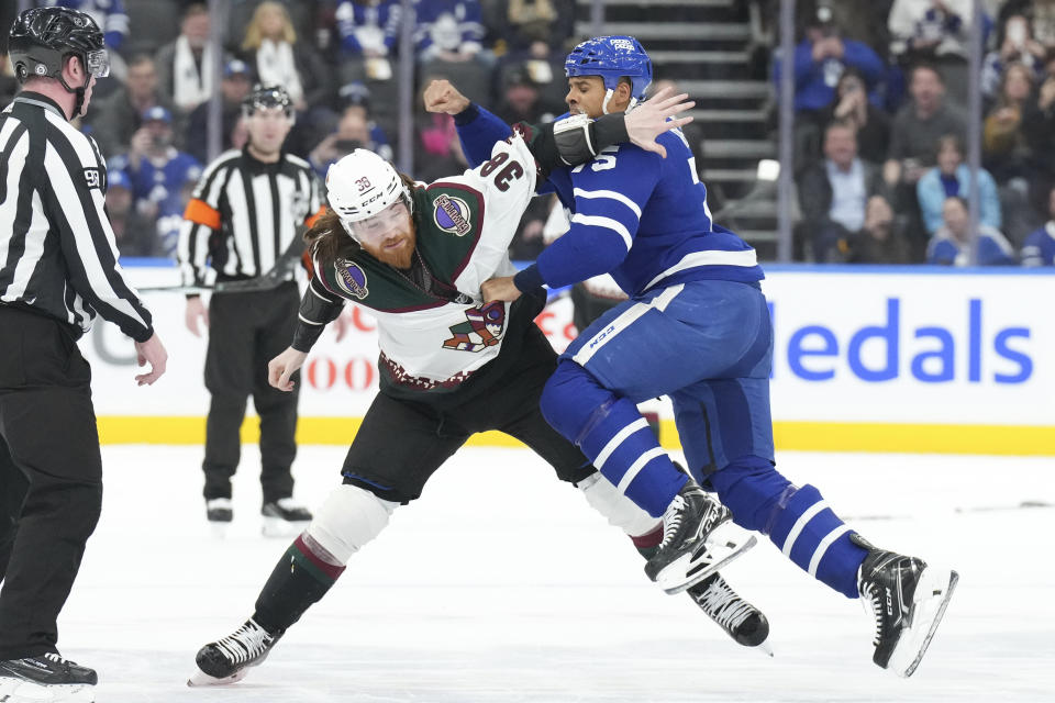 Toronto Maple Leafs' Ryan Reaves, right, Arizona Coyotes' Liam O'Brien (38) fight during first-period NHL hockey game action in Toronto, Thursday, Feb. 29, 2024. (Chris Young/The Canadian Press via AP)