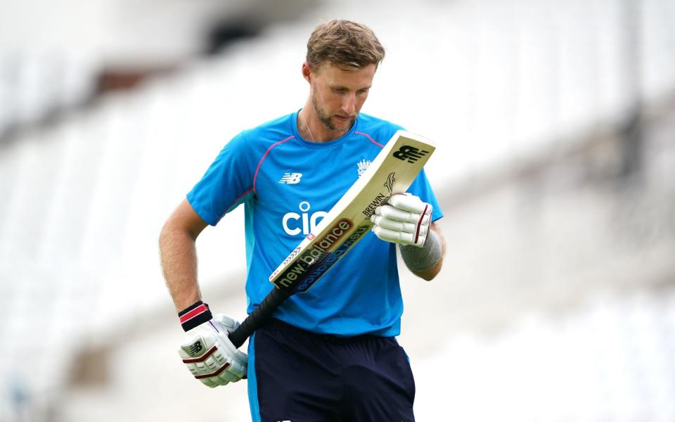 Joe Root looks at his bat in training - PA