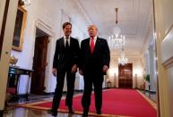 Trump and Netherlands' Prime Minister Rutte take part in a flag presentation at the White House in Washington