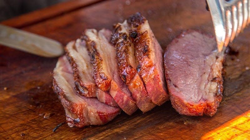 Meat sliced on cutting board