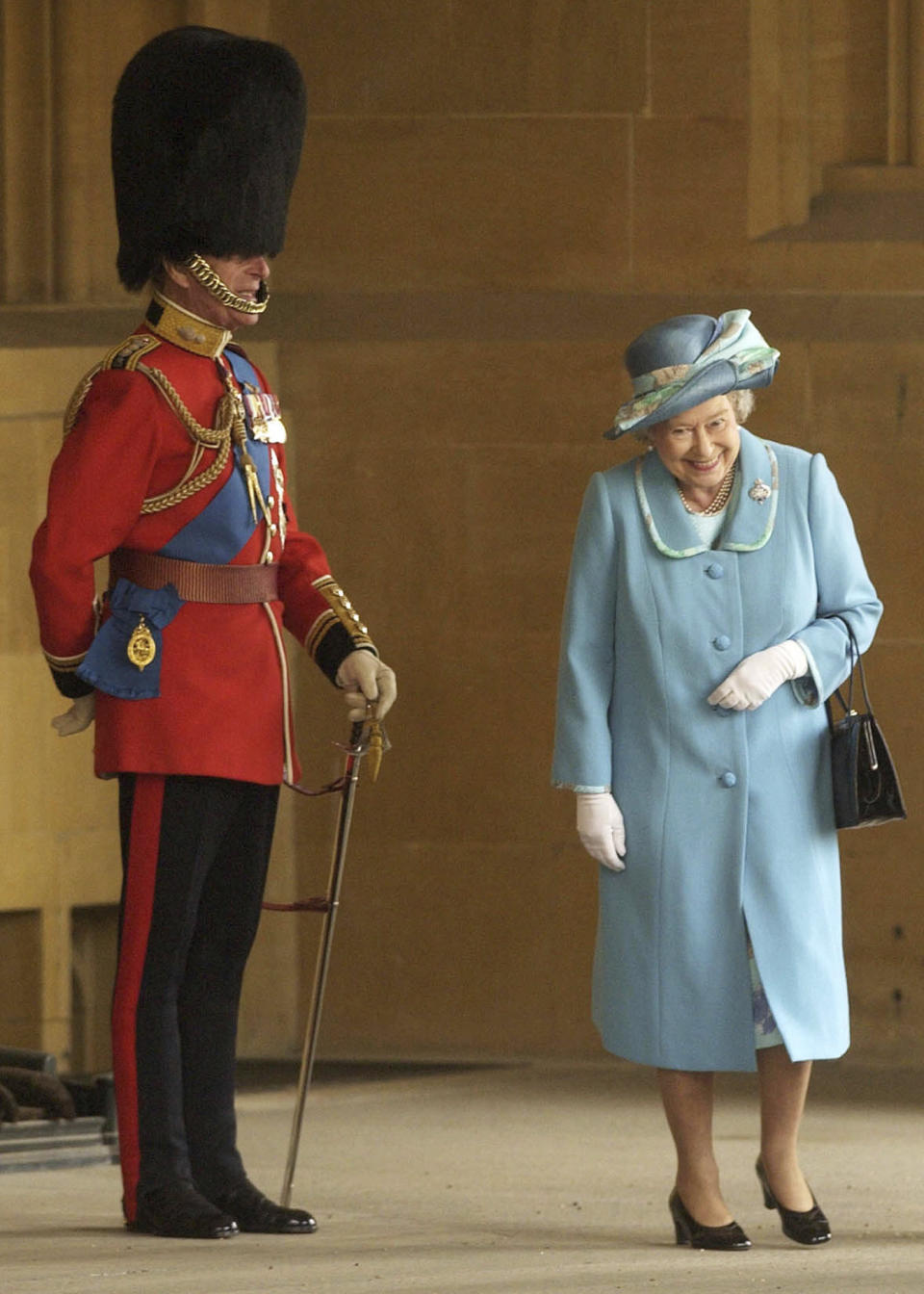 FILE - In this Tuesday April 15, 2003 file photo, Britain's Queen Elizabeth II and Prince Philip prior to The Queen's Company Grenadier Guards ceremonial review at Windsor Castle, Windsor, England. Buckingham Palace says Prince Philip, husband of Queen Elizabeth II, has died aged 99. (AP Photo/Chris Young, Pool, file)
