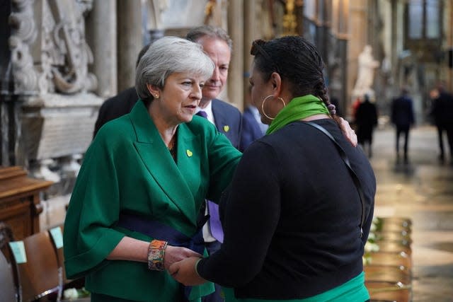 Theresa May and community volunteer Claire Walker speak before the Grenfell fire memorial service at Westminster Abbey in London, in remembrance of those who died in the Grenfell Tower