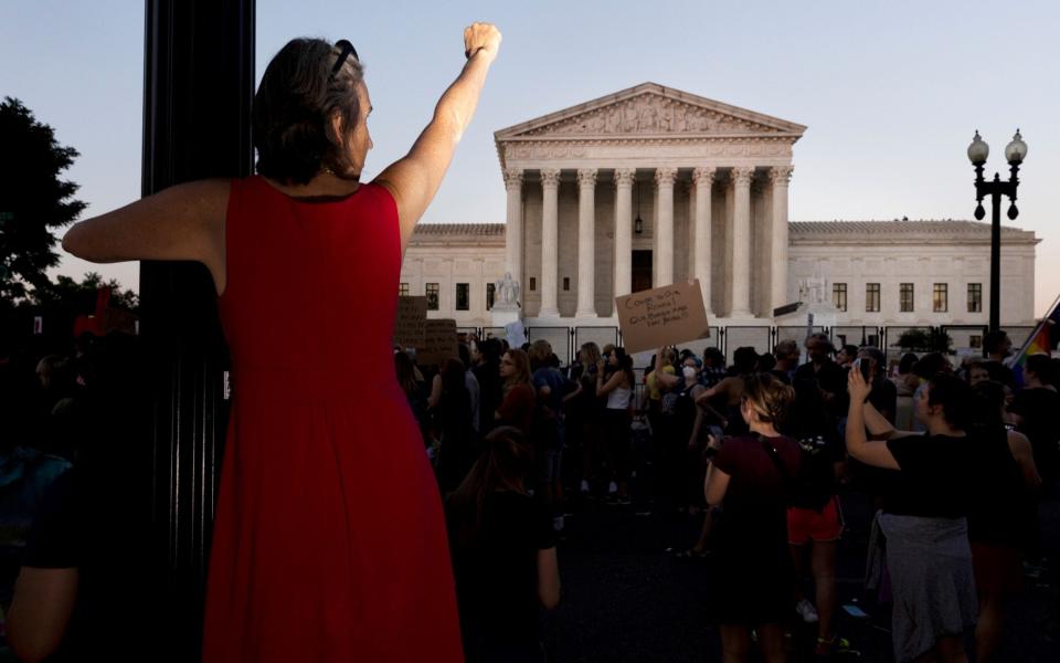 Abortion rights activists protest outside the Supreme Court after it threw out the 50-year-old ruling guaranteeing abortion as a nationwide constitutional right - Shutterstock