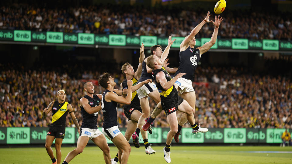 Carlton and Richmond players fly for the ball.