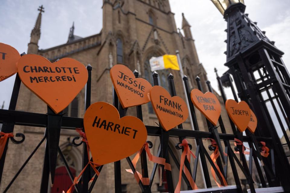 Signs printed with the names of Residential School victims are tied to the gates outside St. Michael’s Cathedral Basilica in Toronto in April 2022. THE CANADIAN PRESS/Yader Guzman