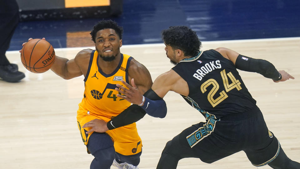 Utah Jazz guard Donovan Mitchell (45) drives around Memphis Grizzlies forward Dillon Brooks (24) in the first half during an NBA basketball game Saturday, March 27, 2021, in Salt Lake City. (AP Photo/Rick Bowmer)