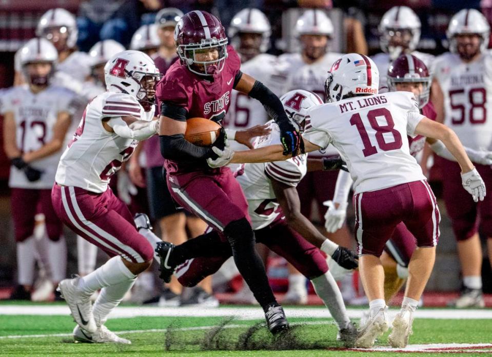 A pack of Altoona defenders can’t stop State College’s D’Antae Sheffey during the game on Friday, Sept. 15, 2023.