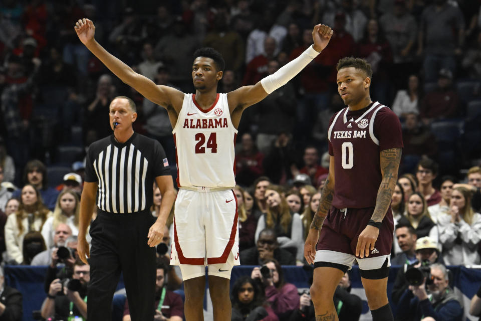 Alabama forward Brandon Miller (24) reacts as Texas A&M guard Dexter Dennis (0) looks on in the final minutes of an NCAA college basketball game in the finals of the Southeastern Conference Tournament, Sunday, March 12, 2023, in Nashville, Tenn. (AP Photo/John Amis)