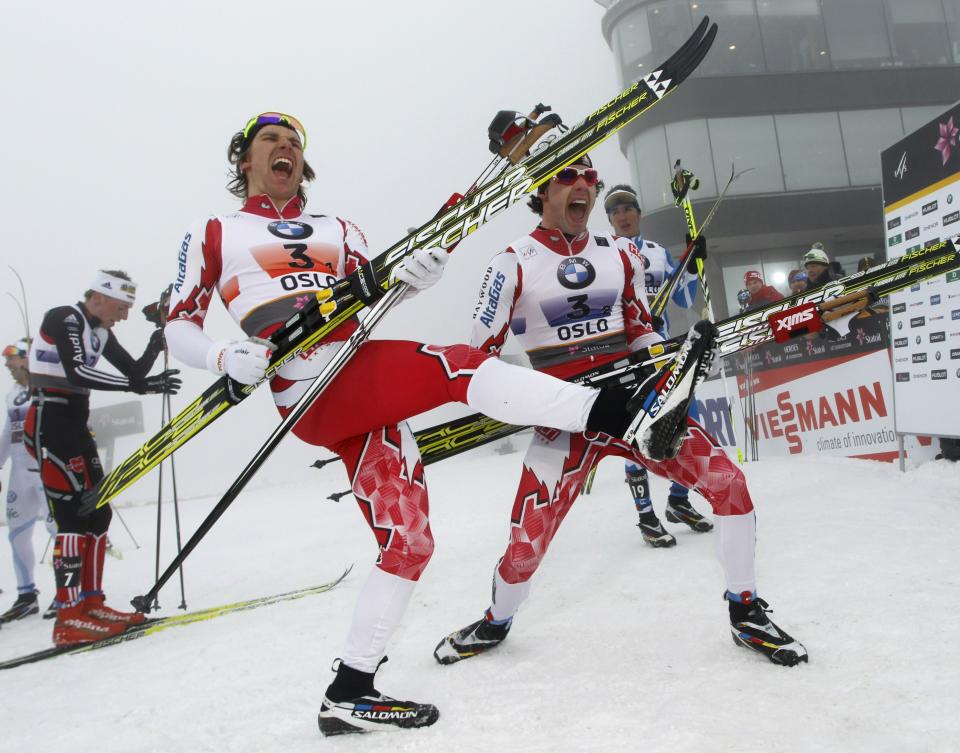 Canada's gold medalists Devon Kershaw (L) and Alex Harvey (R) celebrate by playing air guitar on their skis after crossing the finish line in the Men's Team Sprint Classic event at the Nordic Skiing World Championships in Oslo, March 2, 2011. AFP PHOTO/ DANIEL SANNUM LAUTEN (Photo credit should read DANIEL SANNUM LAUTEN/AFP/Getty Images)