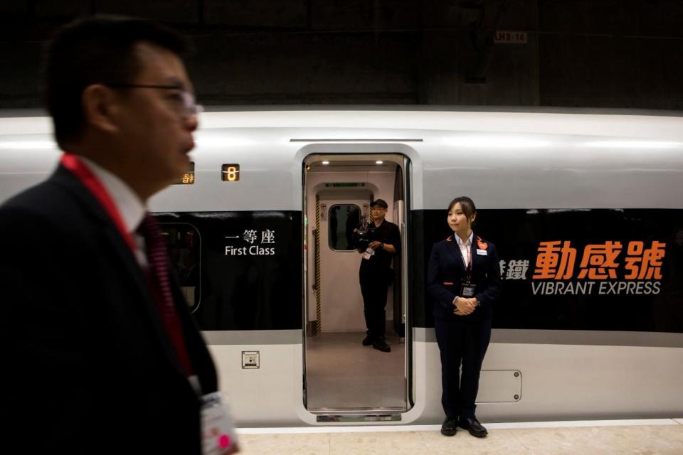 An attendant stands on duty near the high-tech new train service (AP)